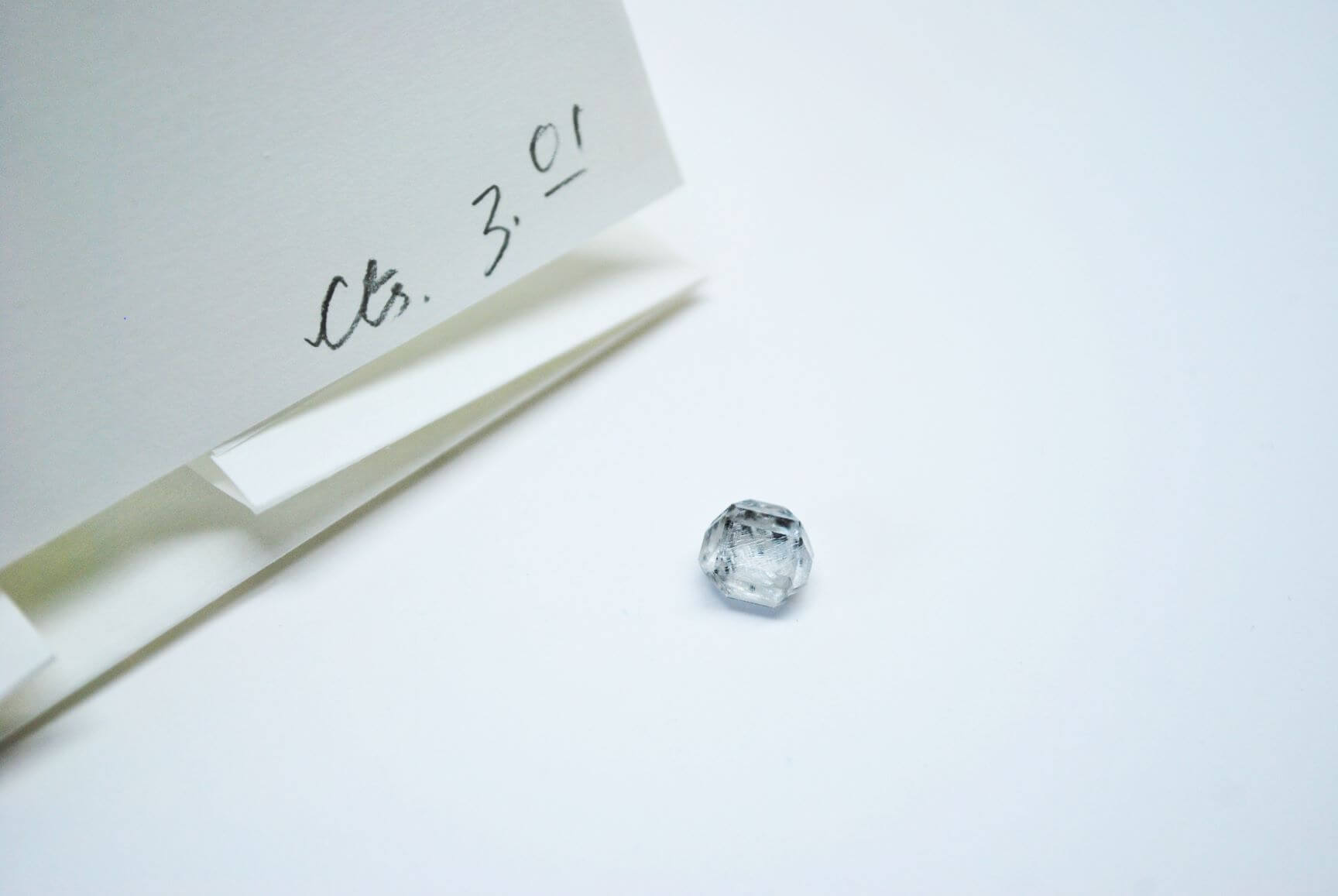 CVD HPHT lab grown rough solitaire diamond with its parcel paper