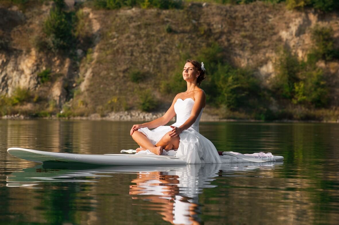 bride relaxing on surfboard