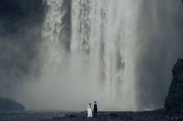 bride and groom iceland waterfall