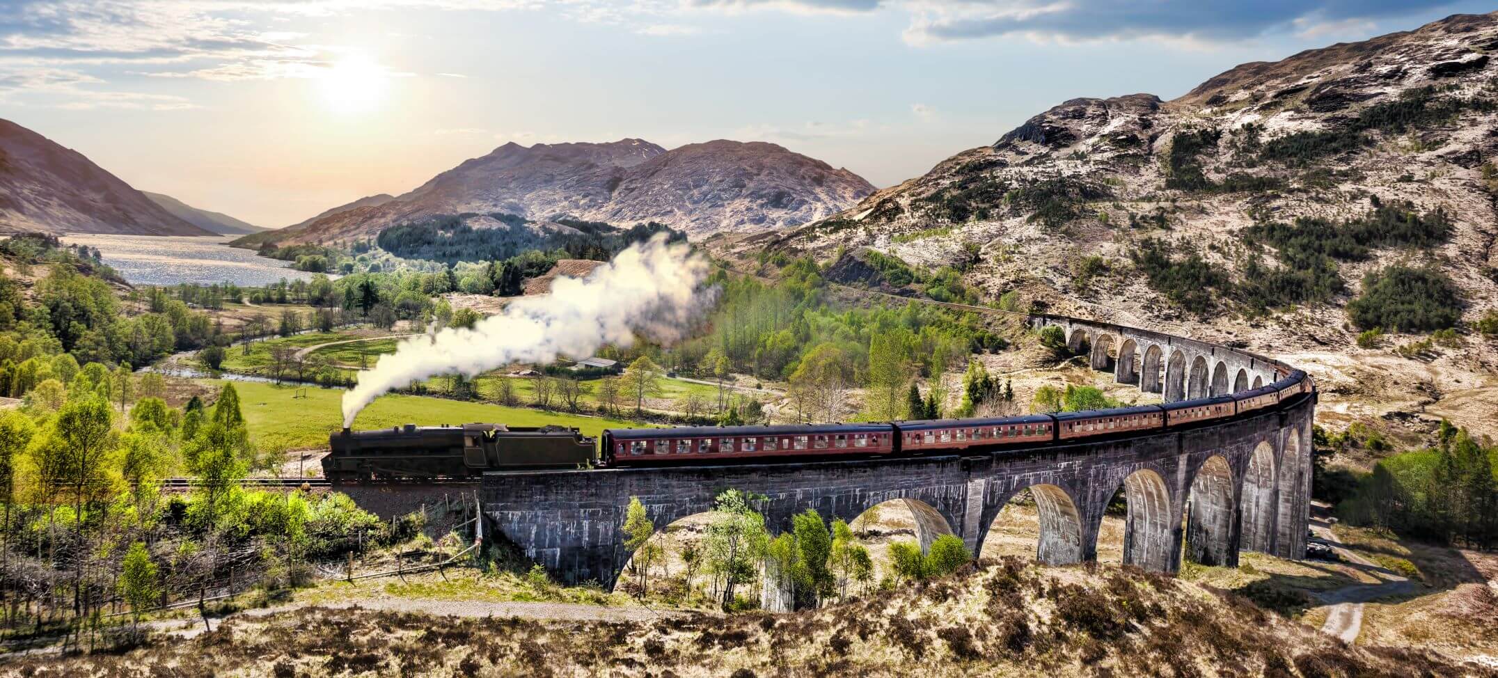 Glenfinnan Railway Viaduct in Scotland with the Jacobite steam train